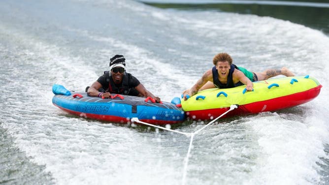 Alabama WR Jermaine Burton is tossed around on the raft by coach Nick Saban.
Courtesy of Alabama Football