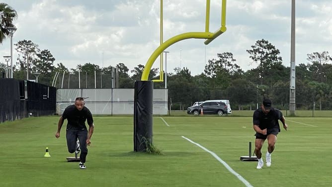 Gabe Davis and teammate Matt Milano work out.