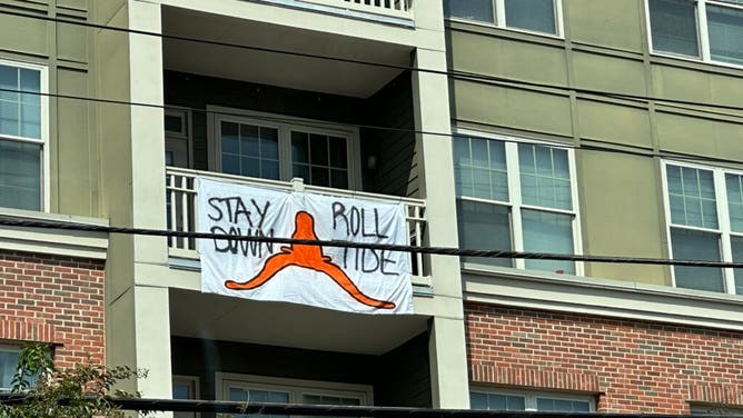 Alabama fans having a little fun with Texas fans with signs outside their house