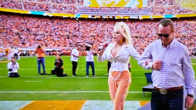 Peyton Manning escorts Dolly Parton onto the field at Tennessee.
Courtesy of Tennessee Athletics