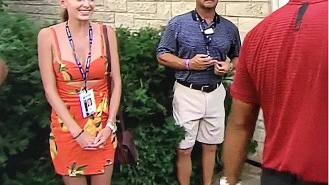 Jena Sims looking at Tiger Woods