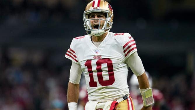 San Francisco 49ers quarterback Jimmy Garoppolo reacts after tight end George Kittle scored a touchdown during the second half of an NFL football game against the Arizona Cardinals, Monday, Nov. 21, 2022, in Mexico City.