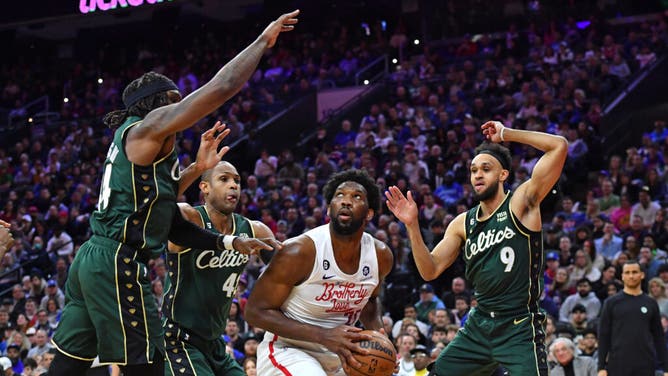 Philadelphia 76ers C Joel Embiid is surrounded by Boston Celtics bigs Robert Williams III and Al Horford and G Derrick White at Wells Fargo Center in Philadelphia.