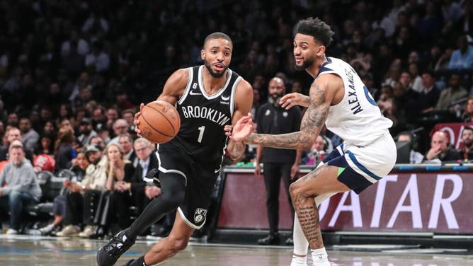 Nets wing Mikal Bridges drives past Minnesota Timberwolves SG Nickeil Alexander-Walker at Barclays Center in Brooklyn.