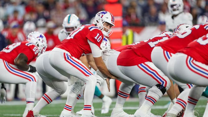 New England Patriots QB Mac Jones at the line of scrimmage vs. the Miami Dolphins at Gillette Stadium in Foxborough, Massachusetts.