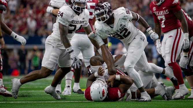 Texas A&M Aggies LB Chris Russell Jr. and defensive lineman Malick Sylla celebrate a sack of Arkansas Razorbacks QB KJ Jefferson at AT&T Stadium.