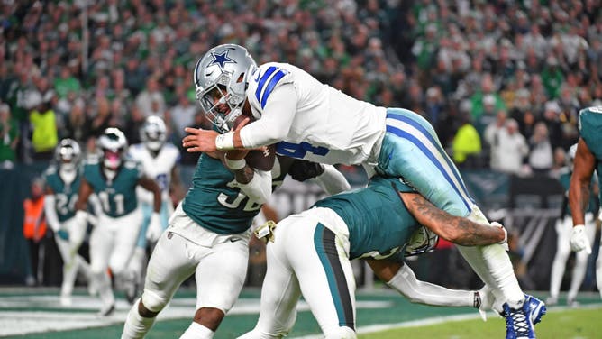 Cowboys QB Dak Prescott is upended by Eagles LB Zach Cunningham and CB Darius Slay.