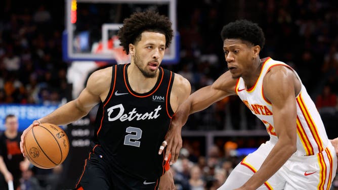 Pistons PG Cade Cunningham attacks the paint with Atlanta Hawks forward De'Andre Hunter playing defense at Little Caesars Arena in Detroit.
