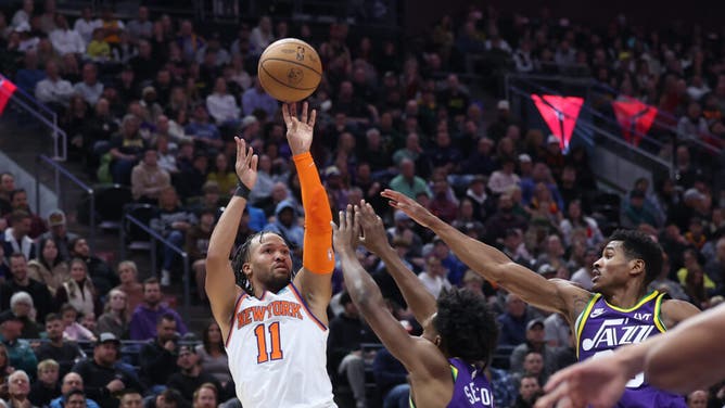 New York Knicks PG Jalen Brunson shoots a fadeaway over Utah Jazz SG Collin Sexton at the Delta Center in Salt Lake City.