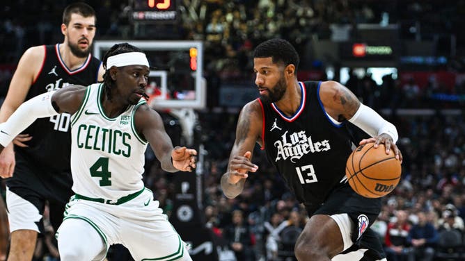 Clippers wing Paul George attacks the paint on Boston Celtics PG Jrue Holiday at Crypto.com Arena in Los Angeles.