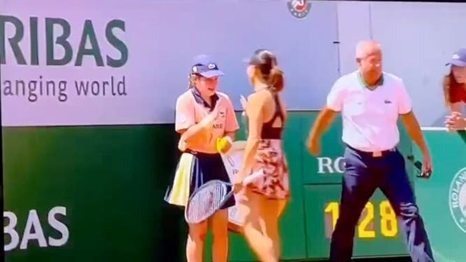 Miyu Kato appears to apologize to a ball girl after accidentally hitting her with a ball at the French Open.