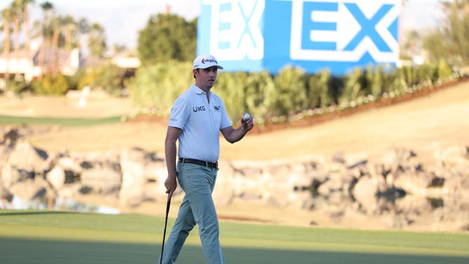 J.T. Poston waves on the 18th green during the final round of The American Express 2023 in La Quinta, California.