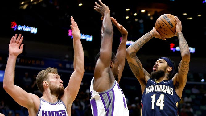 Pelicans wing Brandon Ingram shoots over Kings SF Harrison Barnes and big Domantas Sabonis at Smoothie King Center.