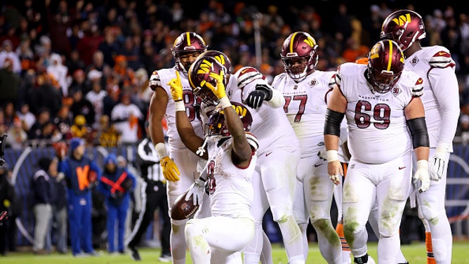 Brian Robinson celebrates his first career touchdown for the Washington Commanders