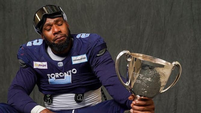 Toronto Argonauts defensive end Shawn Oakman gets emotional while holding the Canadian Football League's Grey Cup.