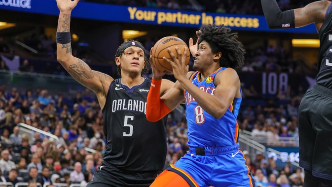 Oklahoma City Thunder SF Jalen Williams drives to the basket on Orlando Magic PF Paolo Banchero at Amway Center in Florida.