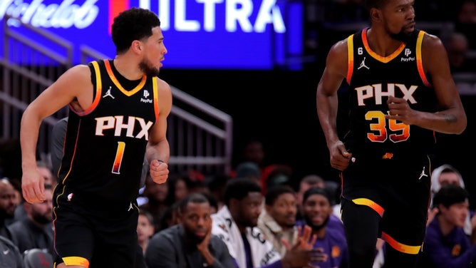 Phoenix Suns All-Stars Devin Booker and Kevin Durant run down the court after made basket vs. the Rockets at Toyota Center in Houston, Texas.