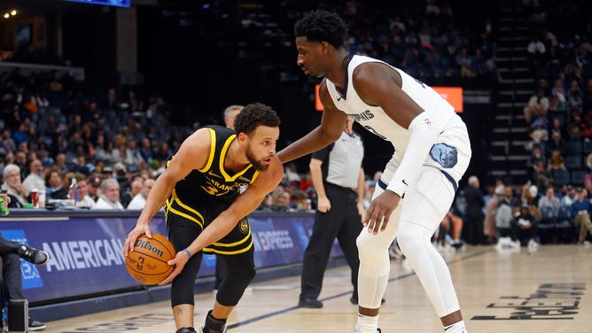 Golden State Warriors' All-Star Stephen Curry handles vs. Grizzlies big Jaren Jackson Jr. at FedExForum in Memphis, Tennessee.