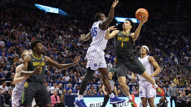Baylor Bears guard Miro Little goes to the hoop on Brigham Young Cougars forward Fousseyni Traore at the Marriott Center.