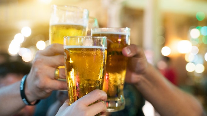 Woman goes viral for complaining her husband likes to drink beer and play football. (Credit: Getty Images)