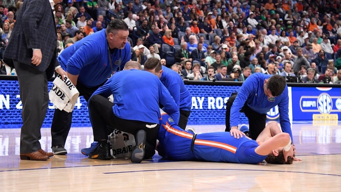Trainers attend to Florida Gators C Micah Handlogten after he broke his leg against the Auburn Tigers at Bridgestone Arena. (Steve Roberts-USA TODAY Sports)