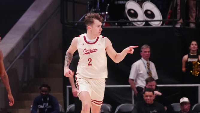 Charleston Cougars guard Reyne Smith reacts to making a three-point basket during the CAA Men’s Basketball Championship.