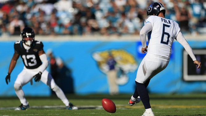 Tennessee Titans kicker Nick Folk attempts an onside kick as Jacksonville Jaguars wide receiver Christian Kirk looks on during the fourth quarter an NFL football game.