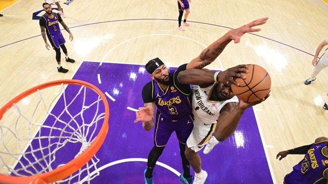 Los Angeles Lakers big Anthony Davis meets New Orleans Pelicans PF Zion Williamson at the basket at Crypto.Com Arena in Los Angeles. (Photo by Adam Pantozzi/NBAE via Getty Images)