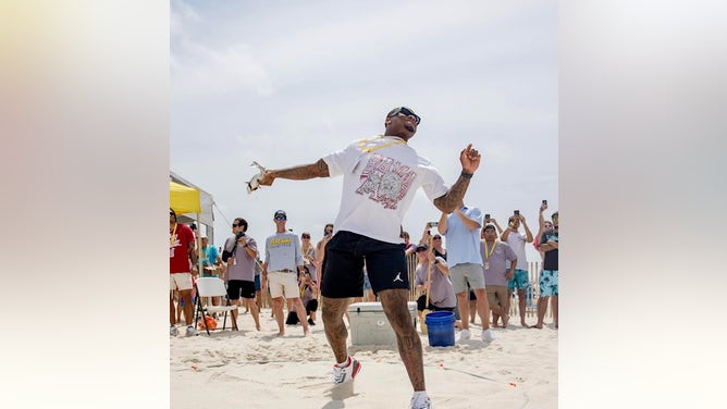 Alabama quarterback Jalen Milroe throws a mullet 94-feet on Saturday at the Flora-Bama lounge Courtesy of C-Shelz Photography