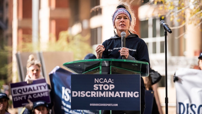 Women's lacrosse coach Kim Russell speaks on stage at the