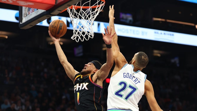 Phoenix Suns SG Devin Booker attempts a layup on Minnesota Timberwolves C Rudy Gobert at Footprint Center in Arizona. (Mark J. Rebilas-USA TODAY Sports)