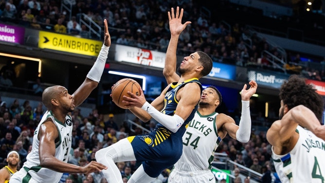Pacers PG Tyrese Haliburton attacks the rim on Milwaukee Bucks forwards Khris Middleton and Giannis Antetokounmpo at Gainbridge Fieldhouse in Indiana. (Trevor Ruszkowski-USA TODAY Sports)
