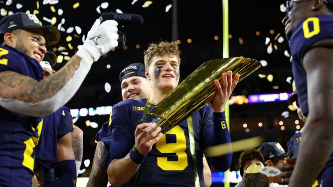 Michigan Wolverines QB J.J. McCarthy holds the trophy as he celebrates winning the 2024 College Football Playoff national championship vs. the Washington Huskies at NRG Stadium in Houston, Texas. (Mark J. Rebilas-USA TODAY Sports)