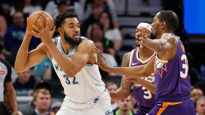 Minnesota Timberwolves big Karl-Anthony Towns looks to pass out of a double-team by Phoenix Suns SG and All-Star Kevin Durant at Target Center. (Bruce Kluckhohn-USA TODAY Sports)