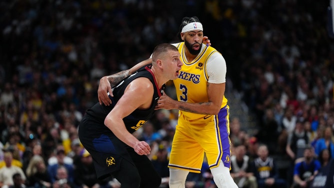 Los Angeles Lakers big Anthony Davis wrestles with Denver Nuggets C Nikola Jokic in the 2024 NBA playoffs at Ball Arena in Colorado. IRon Chenoy-USA TODAY Sports)