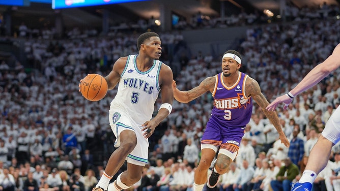 Timberwolves SG Anthony Edwards dribbles around Phoenix Suns SG Bradley Beal in Game 2 of the first round for the 2024 NBA playoffs at Target Center in Minnesota. (Brad Rempel-USA TODAY Sports)