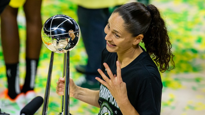Seattle Storm guard Sue Bird poses with the championship trophy after winning the 2020 WNBA Finals.