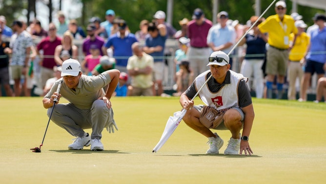 Xander Schauffele and his caddie line up a putt during Round 3 of the 2023 Wells Fargo Championship. (Jim Dedmon-USA TODAY Sports)