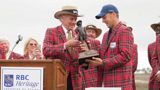 Jordan Spieth accepts the champions trophy after winning the 2022 RBC Heritage at Harbour Town Golf Links in Hilton Head Island, South Carolina. (Photo credit: David Yeazell-Imagn Images)