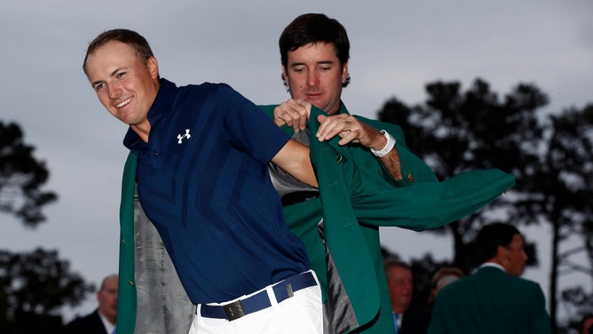 Reigning Masters champion Bubba Watson puts the green jacket on the 2015 Masters champion Jordan Spieth into a green jacket after Spieth at the Augusta National Golf Club. (Photo credit: Rob Schumacher-Imagn Images)