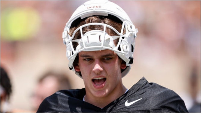 Arch Manning's dad Cooper revealed Eli and Peyton Manning didn't do much mentoring of the Texas QB. What did Cooper say? Will Arch win the Heisman? (Photo by Tim Warner/Getty Images)