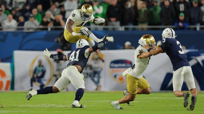Notre Dame Fighting Irish RB Jeremiyah Love leaps over Penn State Nittany Lions LB Kobe King in the second half in the 2025 Orange Bowl at Hard Rock Stadium in Miami. (Photo credit: Sam Navarro-Imagn Images)