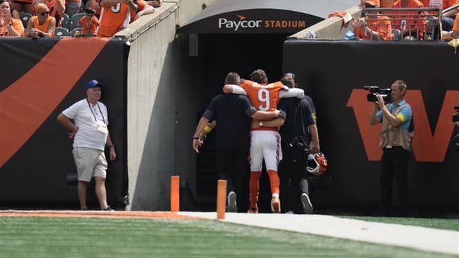 Cincinnati Bengals quarterback Joe Burrow is helped to the locker room after suffering an injury against the Jacksonville Jaguars in Week 2 of the NFL season.