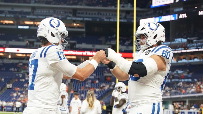 Indianapolis Colts quarterback Daniel Jones and center Tanor Bortolini warm up prior to the game against the Denver Broncos in Week 2 of the NFL season.