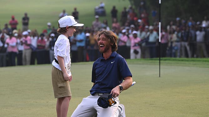 Tommy Fleetwood and his son celebrating victory on a green