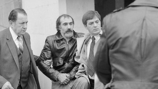 (Original Caption) Hyattsville, Maryland: John Stanfa, 39, (L) is taken from the federal magistrate's office in Hyattsville, Md. after he was ordered taken to Philadelphia. Stanfa is a prime suspect in the slaying of reputed Philadelphia mob boss Angelo Bruno. (Credit: Getty Images)