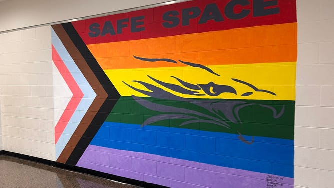 A mural showing the words "Safe Space" and adorned with a pride flag and a transgender flag at Ann Arbor Skyline High School in Michigan.