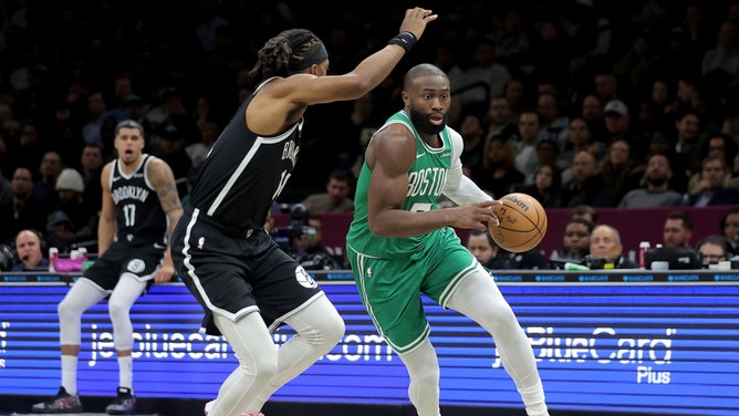 Boston Celtics wing Jaylen Brown driving to the basket on Brooklyn Nets wing Terance Mann at Barclays Center. (Photo credit: Brad Penner-Imagn Images)