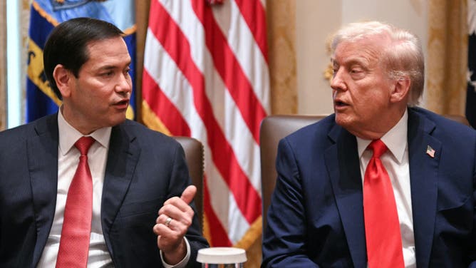 Secretary of State Marco Rubio speaks as US President Donald Trump looks on during a cabinet meeting.