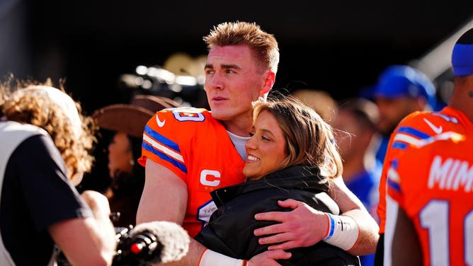 Denver Broncos quarterback Bo Nix hugs his wife, Izzy.